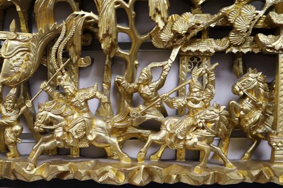 Six Chinese carved giltwood panels of soldiers amid pavilions